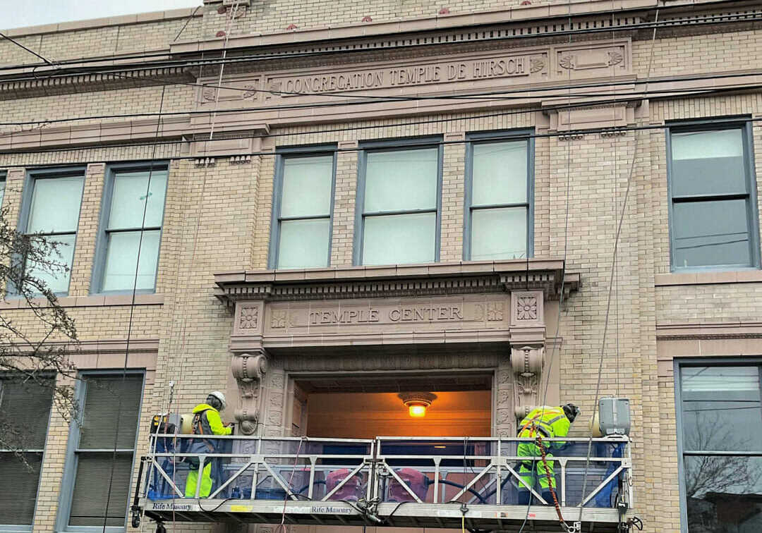 masonry contractor working on brick temple